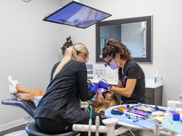 Dentist and assistant treating a patient