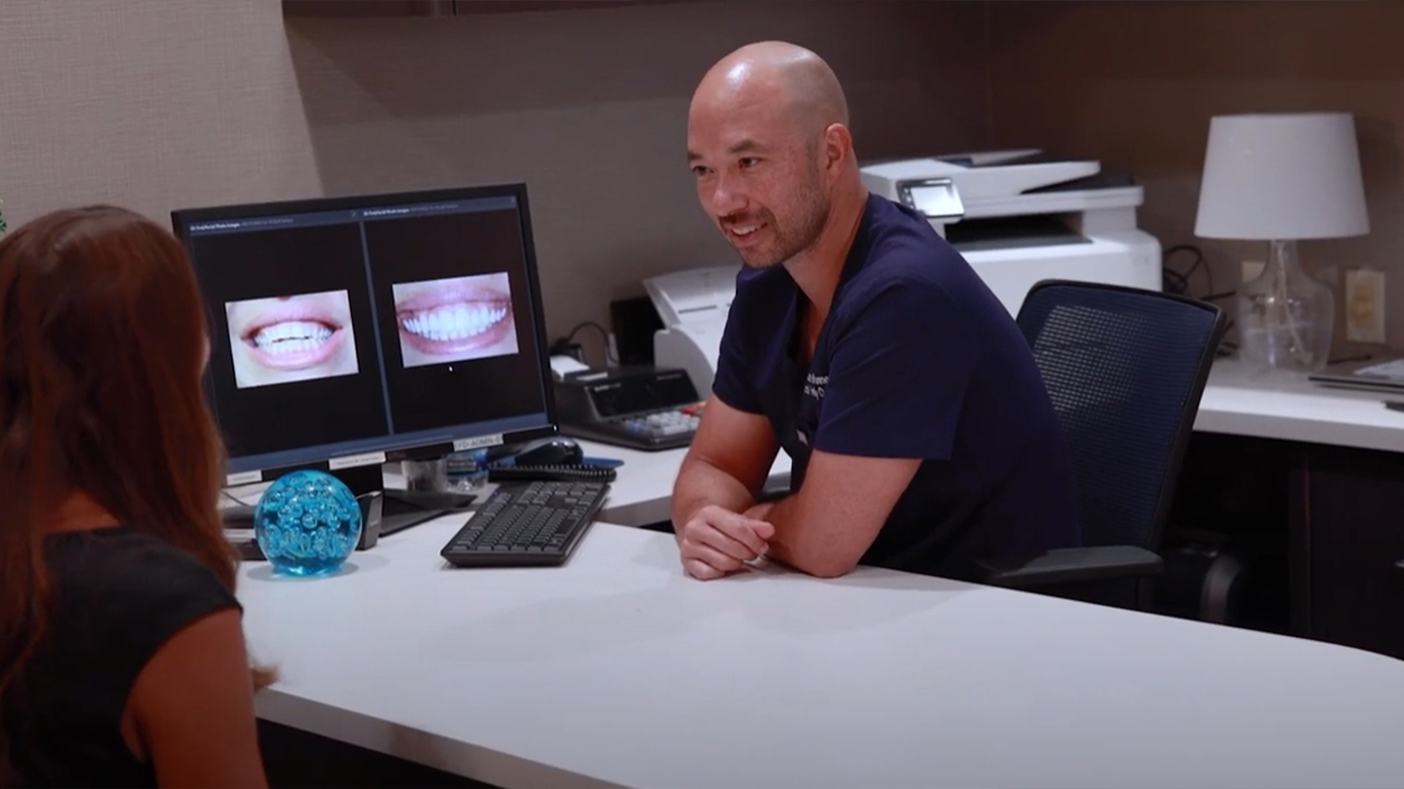 Doctor Brunner sitting across from a dental patient during a consultation