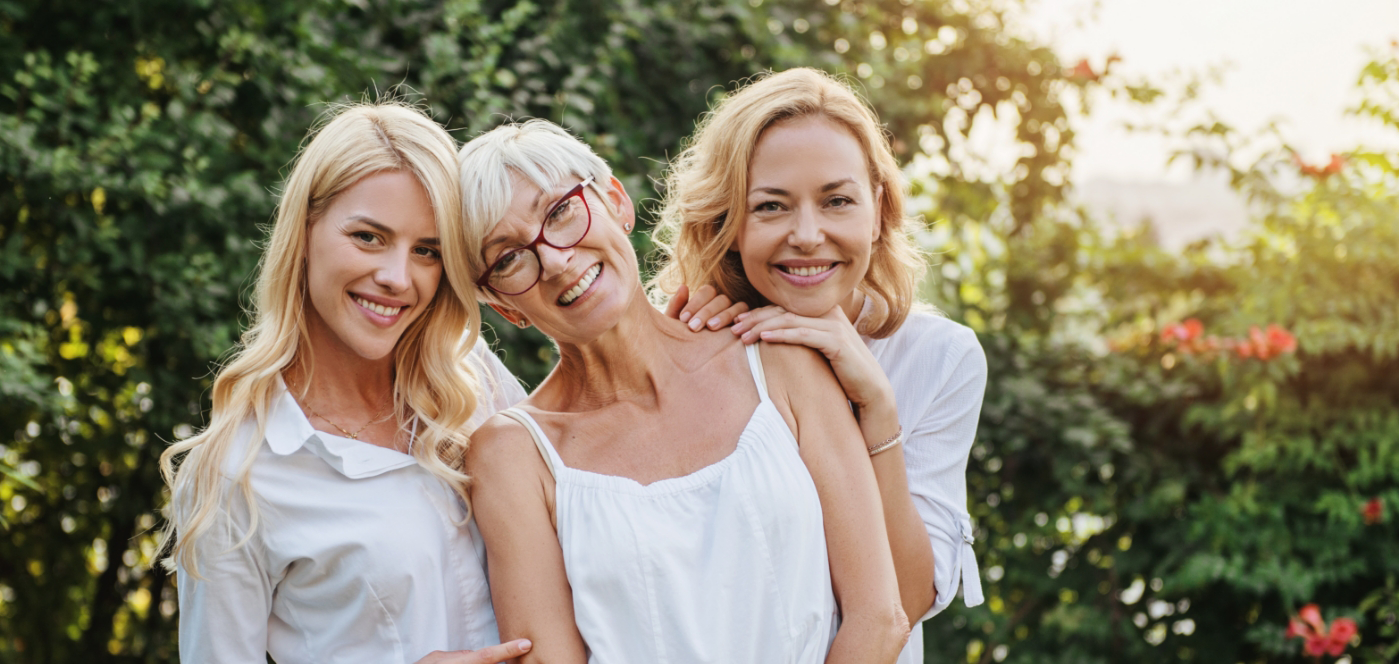 Three women smiling outdoors after cosmetic dentistry in Wauwatosa