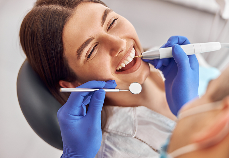 Woman smiling right before her dentist begins a procedure