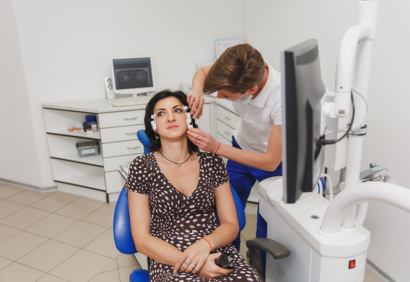 Dental patient having several patches placed on the sides of her face