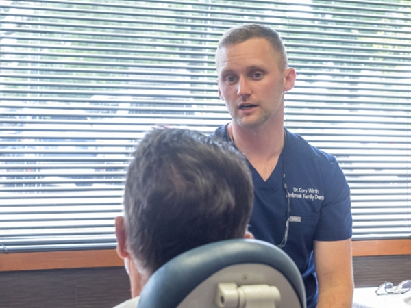 Dentist talking to a patient in the dental chair