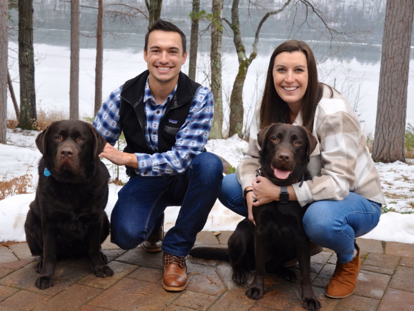 Doctor Barrette and his wife with their two chocolate Labradors