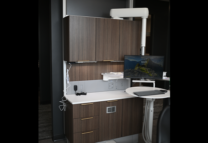 Computer next to countertop in dental treatment room