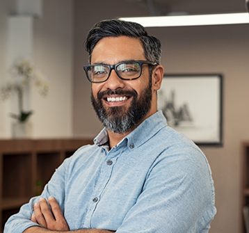 Smiling man in glasses and denim shirt