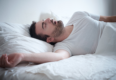 Man sleeping on his back with his mouth open