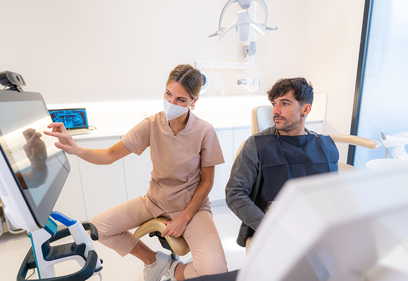 Dentist showing a patient a screen